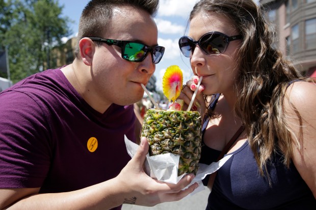 Gabriel Guzman and Ambre Martino, both from Arizona, share a pina colada at Taste of Lincoln Avenue on July 27, 2014. (Michael Tercha/Chicago Tribune)