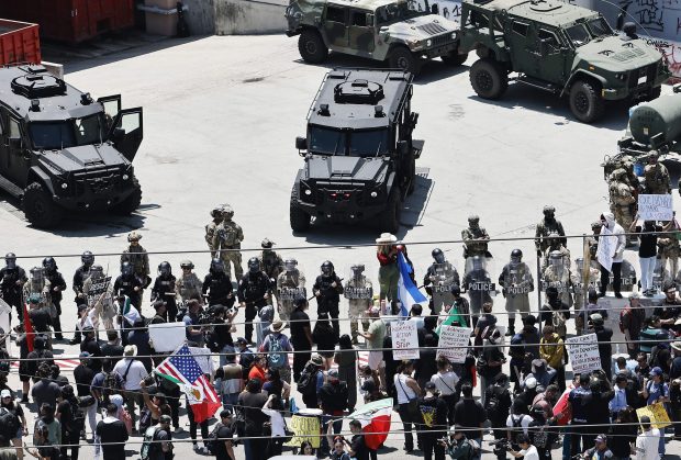 Protesters gather in front of California National Guard soldiers and Los Angeles Police Department officers guarding the Edward R. Roybal Federal building as protests continue in Los Angeles following four days of clashes with police after a series of immigration raids June 10, 2025. (Mario Tama/Getty)
