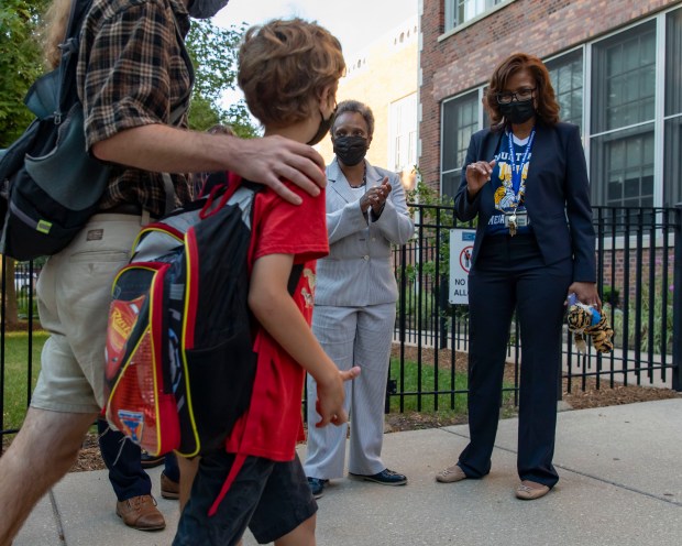 Mayor Lori Lightfoot and then-Principal Macquline King, greet students and parents as they arrive, Aug. 30, 2021, on the first day of school at Mary E. Courtenay Language Arts Center. King is under consideration for the CPS interim CEO position. (Brian Cassella/Chicago Tribune)