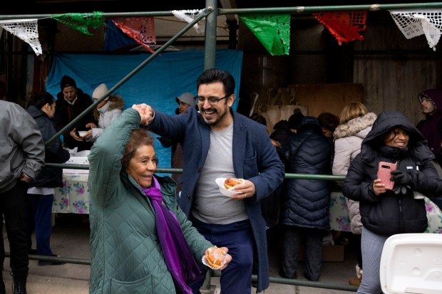 Ald. Byron Sigcho Lopez, 25th, dances with Felipa Arguello during a celebration of the feast of St. Adalbert outside of the church in the Lower West Side neighborhood, April 23, 2023. (Eileen T. Meslar/Chicago Tribune)