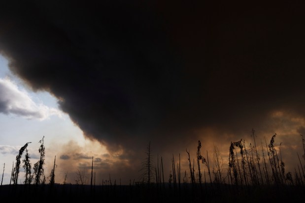 Wildfire smoke hangs in the air above Highway 97 north of Buckinghorse River in British Columbia on May 30, 2025. (Nasuna Stuart-Ulin/The Canadian Press)