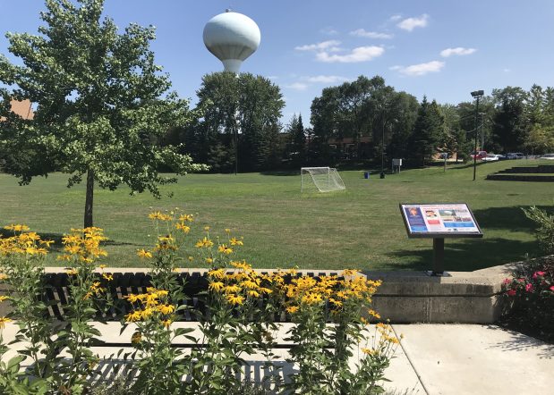 There's no better spot to gaze at the "Save Ferris" water tower than the John Hughes memorial bench by Northbrook Village Hall, shown here in 2018. Hughes filmed the movie "Ferris Bueller's Day Off" in various locations in the Chicago area. (Lori Rackl/Chicago Tribune)